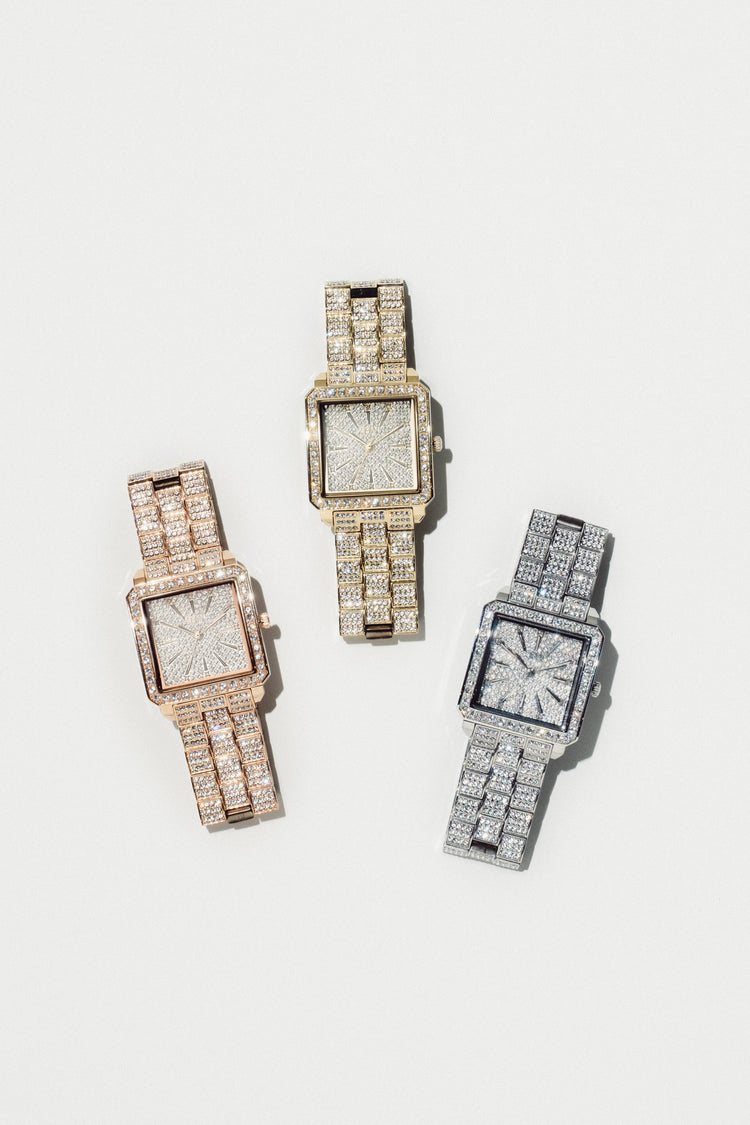 Three luxury square-faced watches fully paved with diamonds, shown in rose gold, yellow gold, and silver-tone metal on a clean off-white background.