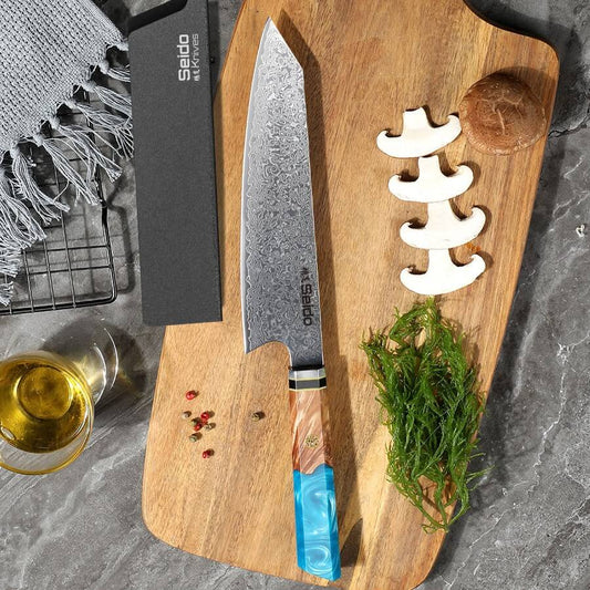 Sakao Damascus kitchen knife with wooden handle and branded packaging on a white background