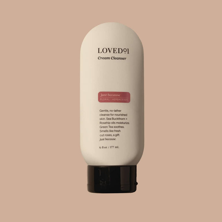 Cream Cleanser bottle with 'LOVED' branding on a beige background
