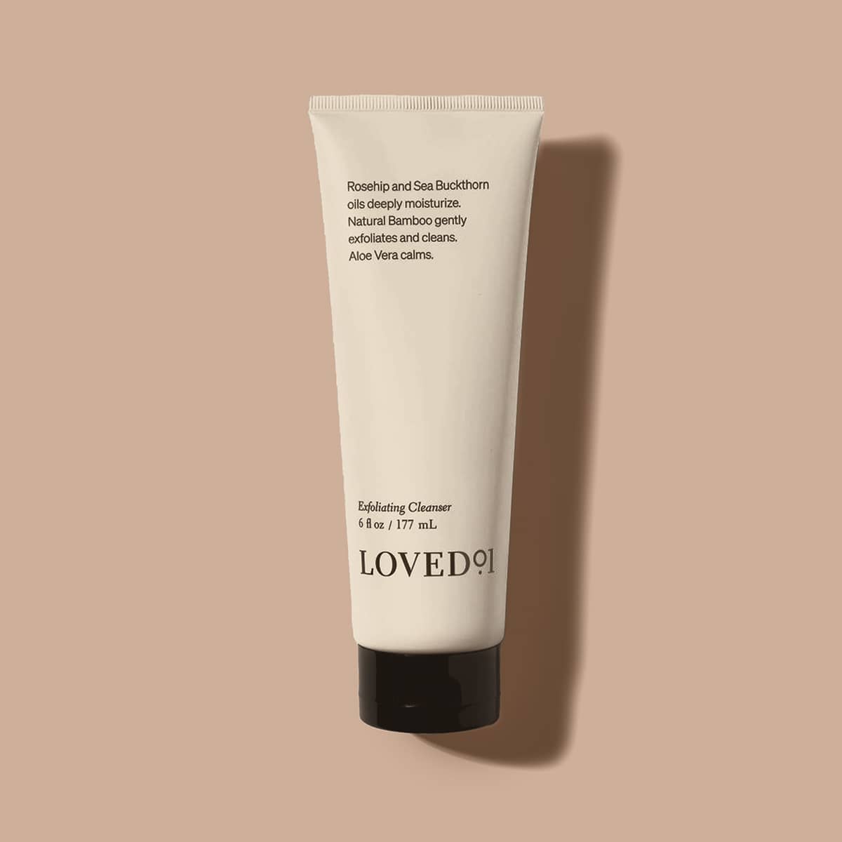 Tube of LOVED101 Exfoliating Cleanser on a beige background