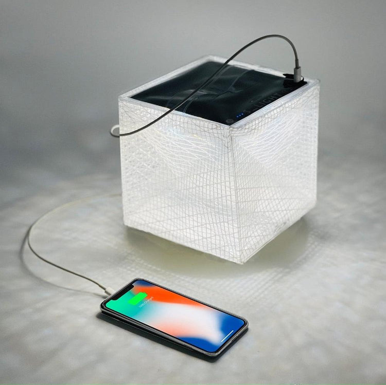 MEGAPUFF solar lantern charging iPhone with panel facing sunlight