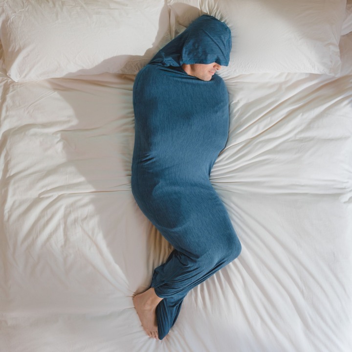 Turquoise#man in Sleep Pod Hood in bed laying down