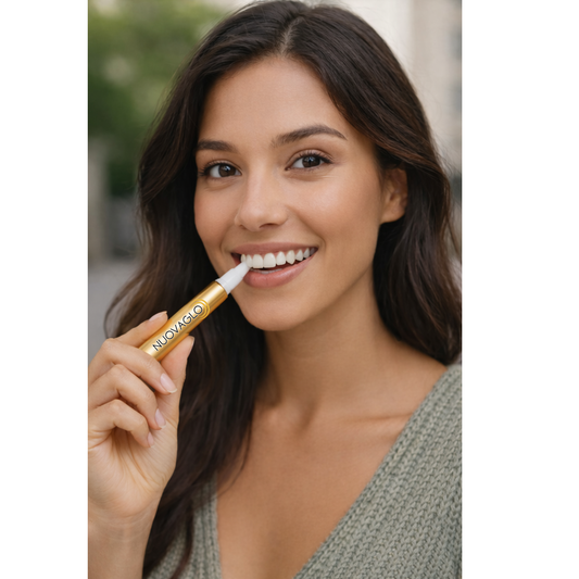 Woman using a teeth whitening device with Nuovaglo packaging and smartphone displaying results.