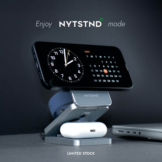 A foldable wireless charger stand with a smartphone, smartwatch, and earbuds being charged.