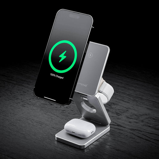 A foldable wireless charger stand with a smartphone, smartwatch, and earbuds being charged.