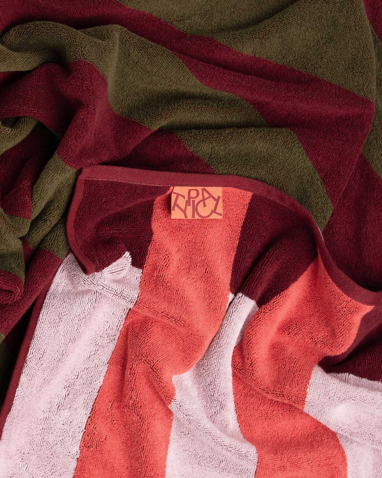 Red and green towel with a brand logo on a white background