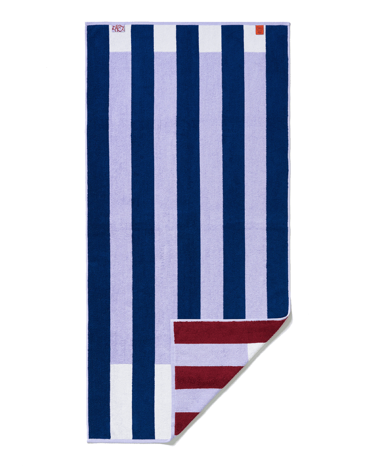 Striped towel with blue, white, and red pattern on a black background
