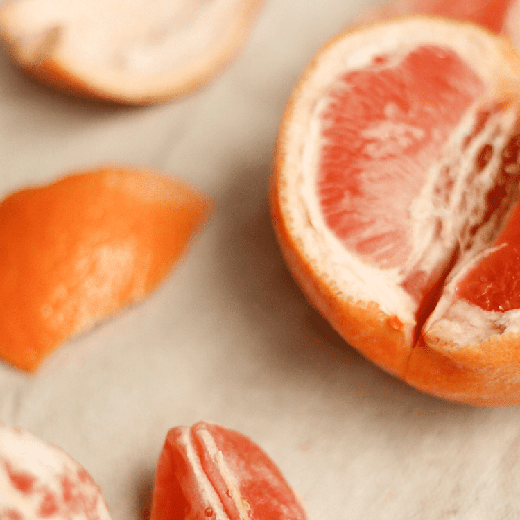 Close-up of sliced grapefruits on a light background