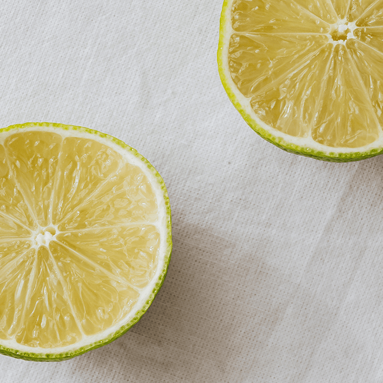Two halves of a lemon on a light fabric background