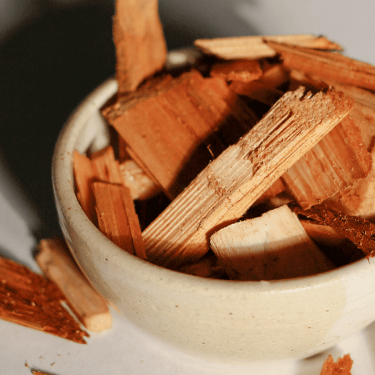 Close-up of cinnamon sticks in a bowl with a blurred background