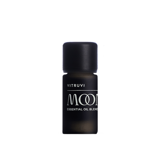 Black bottle of Vitruvi Moone essential oil blend on a transparent background