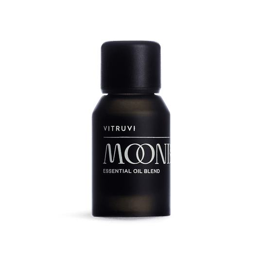 Black bottle of Vitruvi Moone essential oil blend on a transparent background