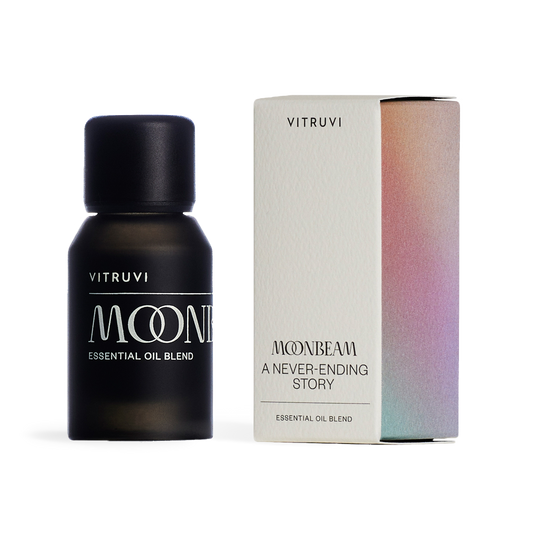 Black bottle of Vitruvi Moone essential oil blend on a transparent background