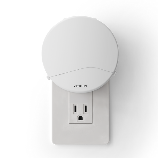 White night light attached to a wall outlet with 'Vitruvi' branding on a white background