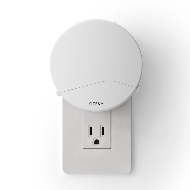 White night light attached to a wall outlet with 'Vitruvi' branding on a white background