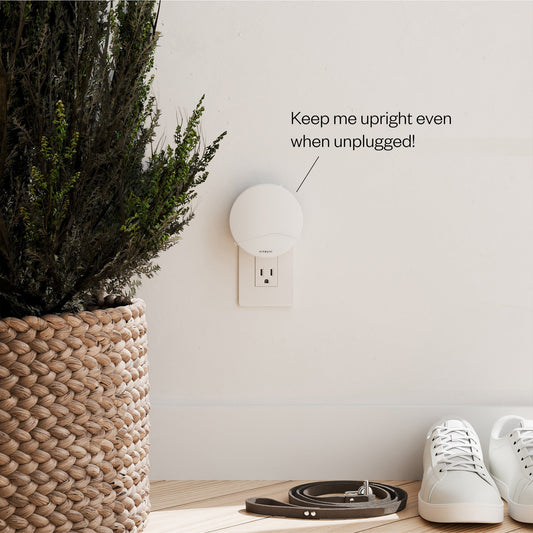 White night light attached to a wall outlet with 'Vitruvi' branding on a white background