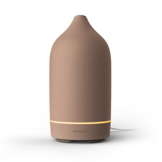 Brown diffuser with a visible brand logo on a white background