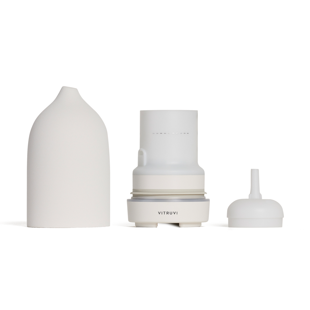 Set of three white ceramic containers with 'Vitruvi' branding on a white background