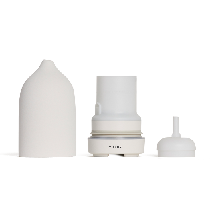 Set of three white ceramic containers with 'Vitruvi' branding on a white background