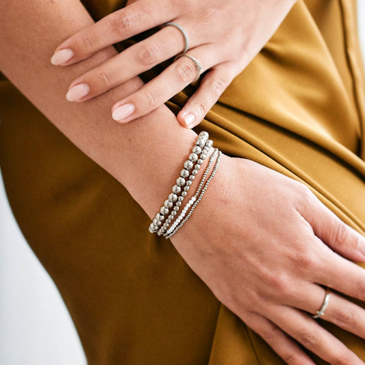 Silver beaded bracelet on a light gray background