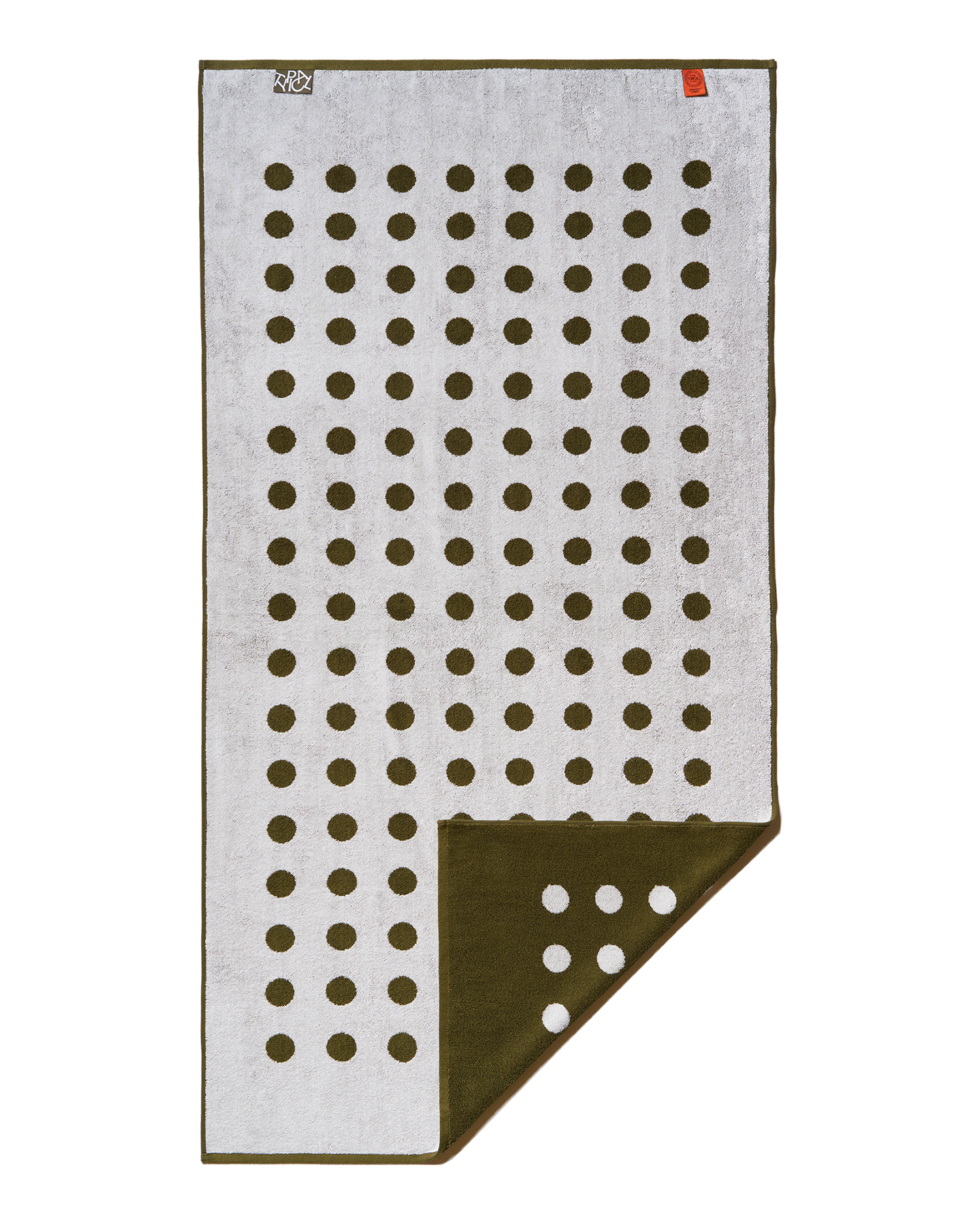 Folded towel with a pattern of brown dots on a white background