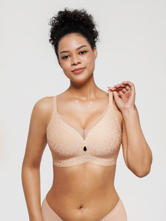 Woman wearing a beige bra against a plain background