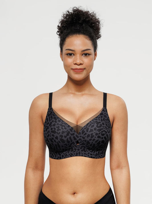 Woman wearing a black leopard print bra against a plain background