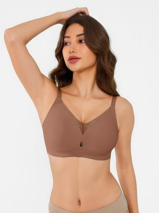 Woman wearing a brown bralette against a plain background