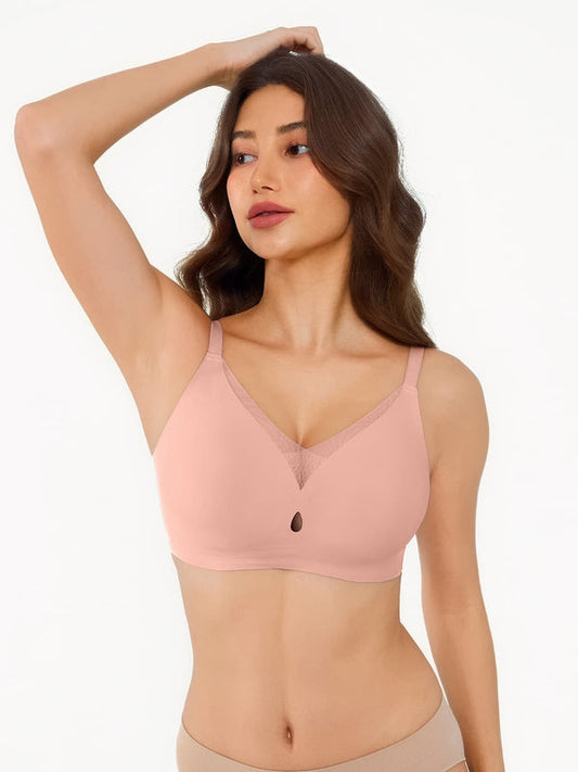 Woman wearing a pink bra against a white background