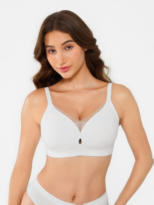 Woman wearing a white bra and underwear set on a plain background