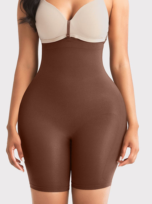 A close-up of a model wearing a high-waisted brown shapewear brief with a beige bra underneath, set against a plain light gray background.
