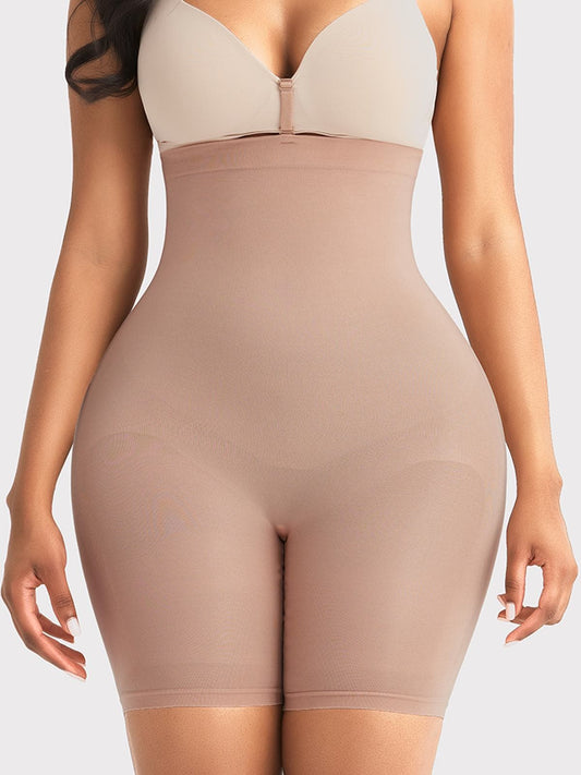 A model wearing a high-waisted beige shapewear brief over a light beige bra, shown from the chest to the upper thighs against a plain light gray background.