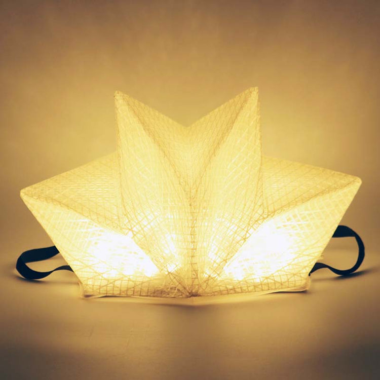 QWNN solar lantern in warm light mode, star crown shape on studio background