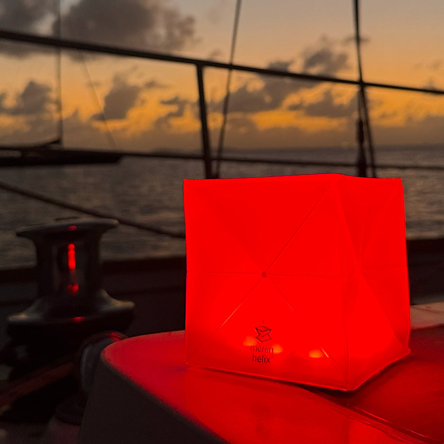 Red solar lantern on a boat for safety lighting.