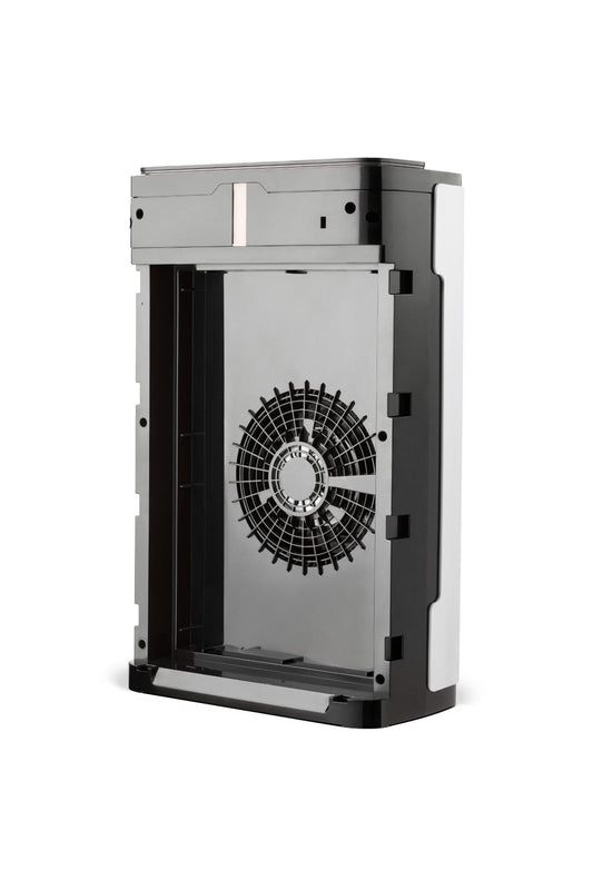 Air purifier on a gray floor with a yellow chair and wooden shelf in the background