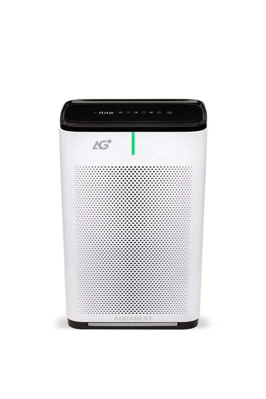 Air purifier on a gray floor with a yellow chair and wooden shelf in the background