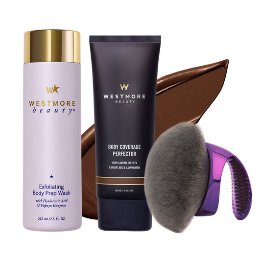 Westmore Beauty hair care set featuring Exfoliating Body Prep Wash in a lavender bottle with a gold cap, Body Coverage Perfector in a dark navy tube with gold lettering, a brown hair swatch, a gray bristle brush, and a purple-handled brush attachment, all on a white background.