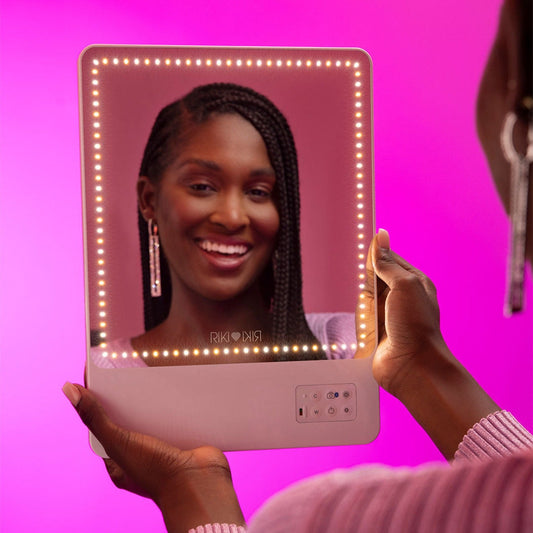 A young woman using RIKI Skinny Duo Vanity Mirror with color temperature lights - RIKI LOVES RIKI 