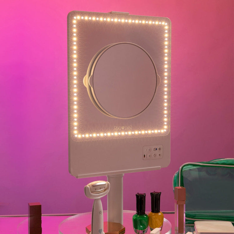 A young woman using RIKI Skinny Duo Vanity Mirror with color temperature lights - RIKI LOVES RIKI 