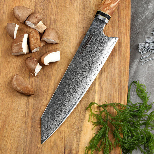 Sakao Damascus kitchen knife with wooden handle and branded packaging on a white background