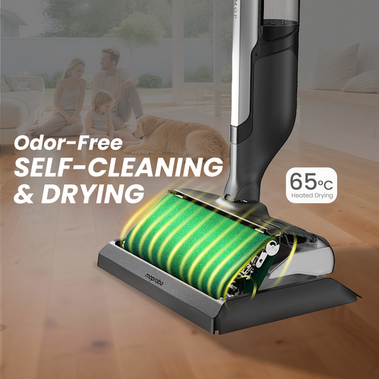 Person using a vacuum cleaner on a wooden floor in a kitchen.