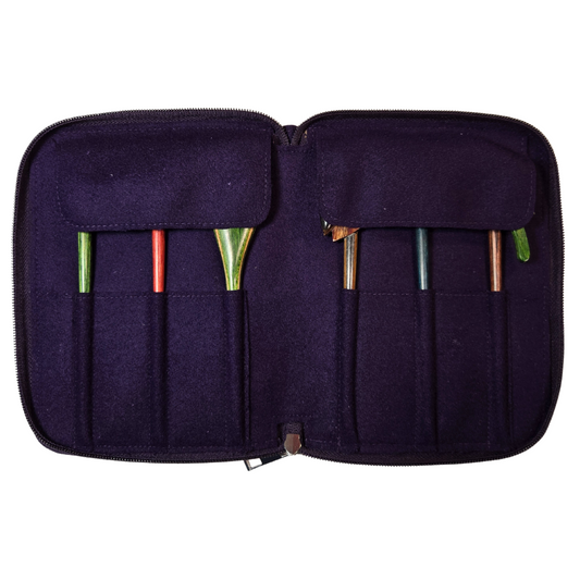 Set of colorful wooden spoons in a black case on a white background