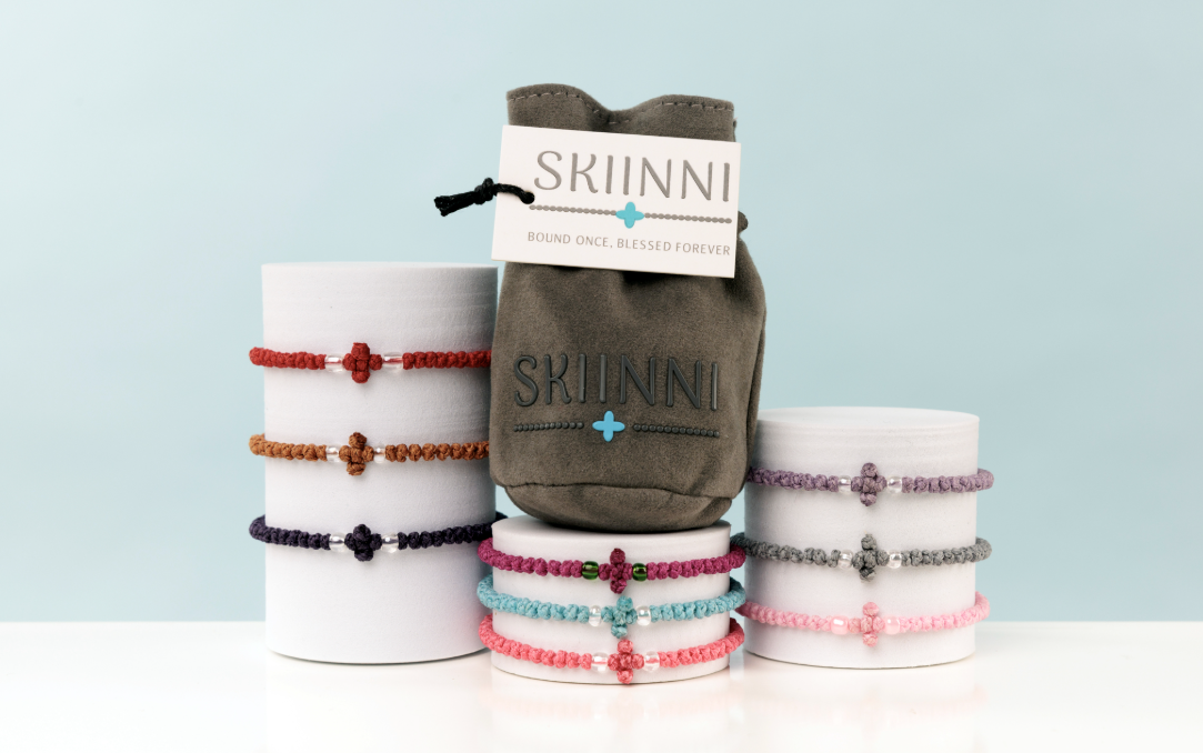 Bracelets and a pouch with 'Skiinni' branding on a light blue background