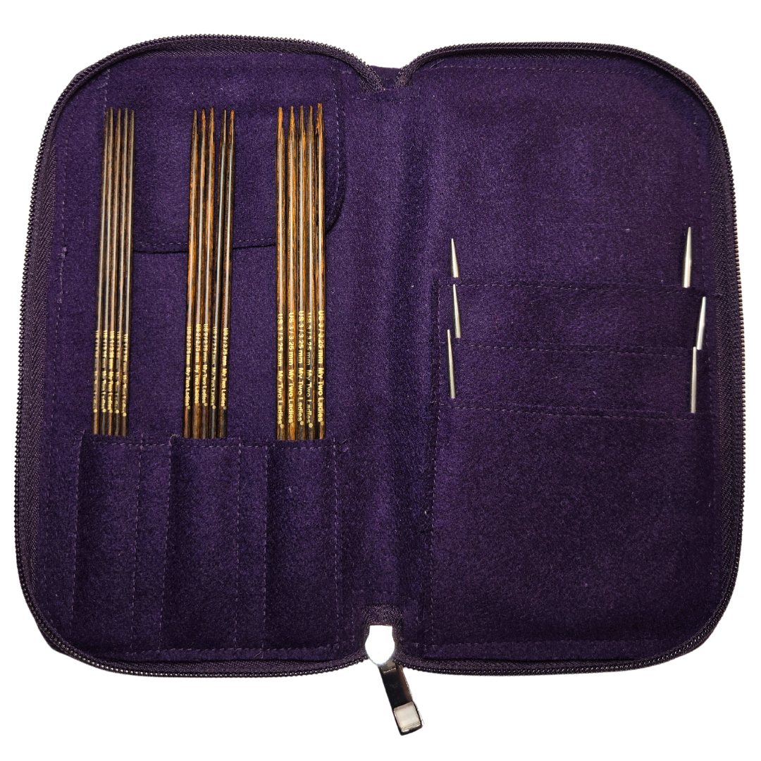 Purple knitting needle case with gold and silver needles on a white background