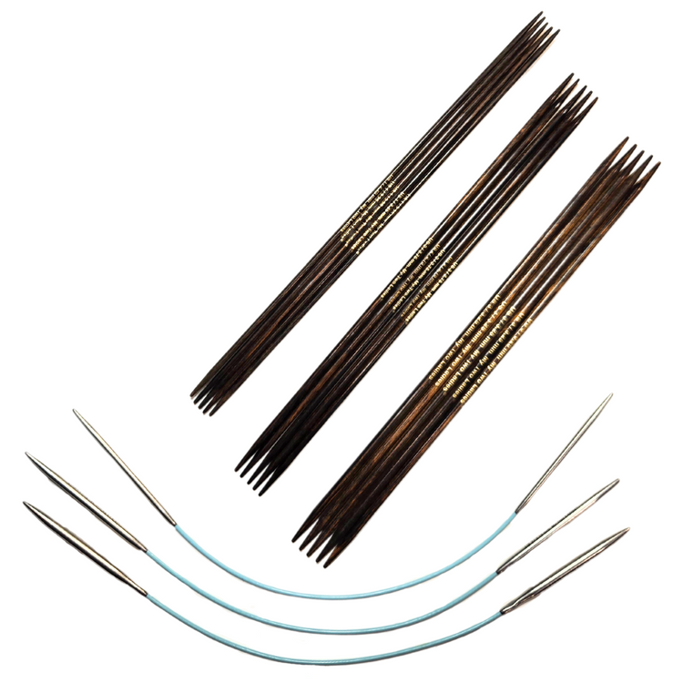 Set of various knitting needles on a white background
