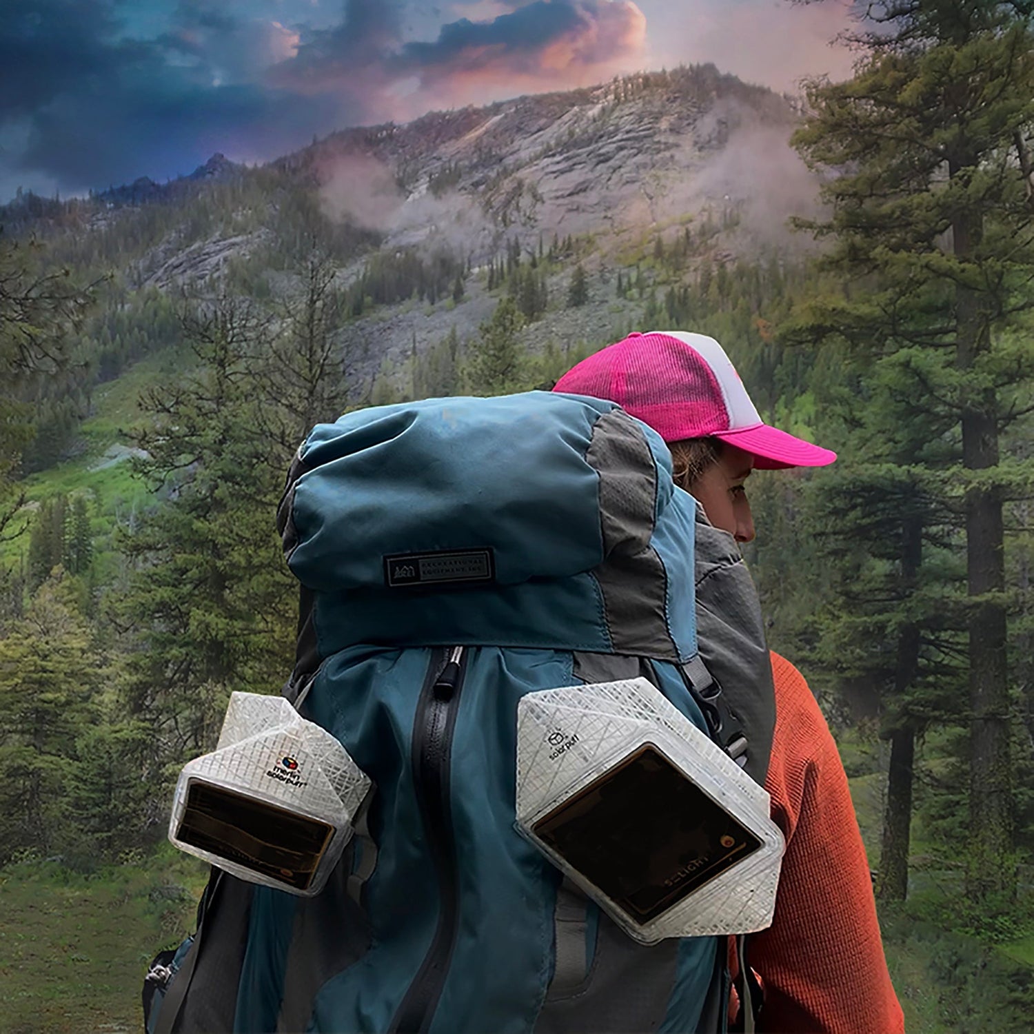 Camper carrying SolarPuff lanterns attached to backpack for off-grid lighting