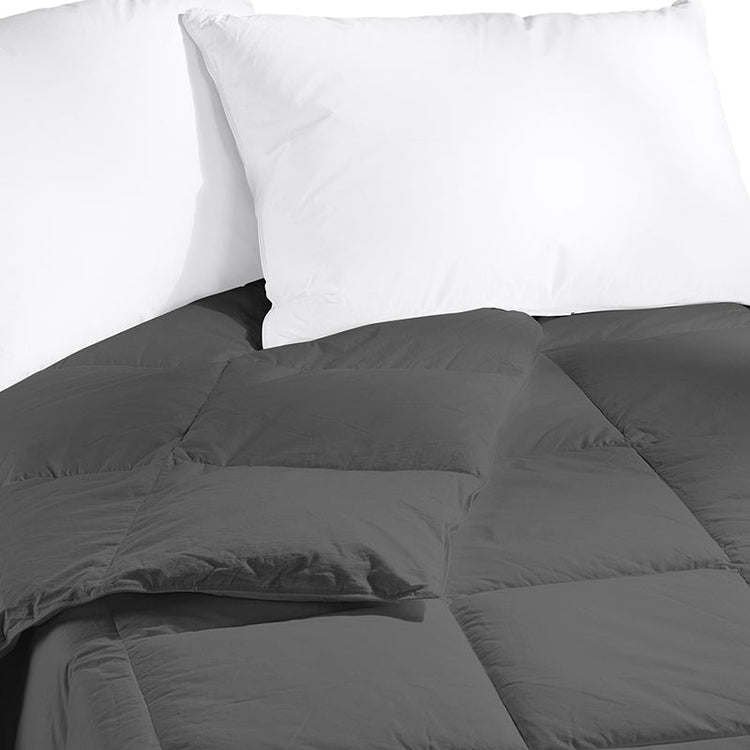 Gray comforter on a bed with white pillows