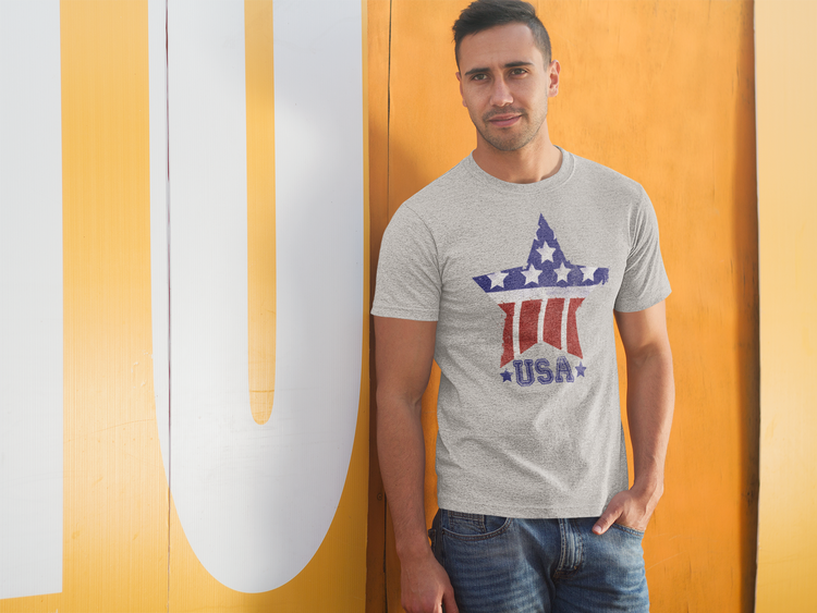 Man wearing a gray t-shirt with a star design against a yellow and white background