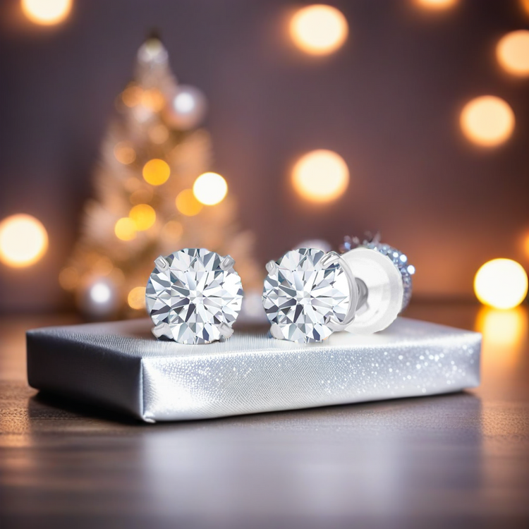 Diamond earrings on a silver box with a blurred festive background