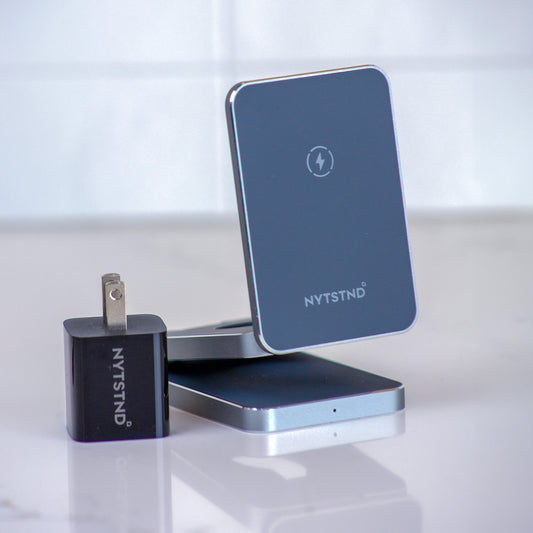 A foldable wireless charger stand with a smartphone, smartwatch, and earbuds being charged.